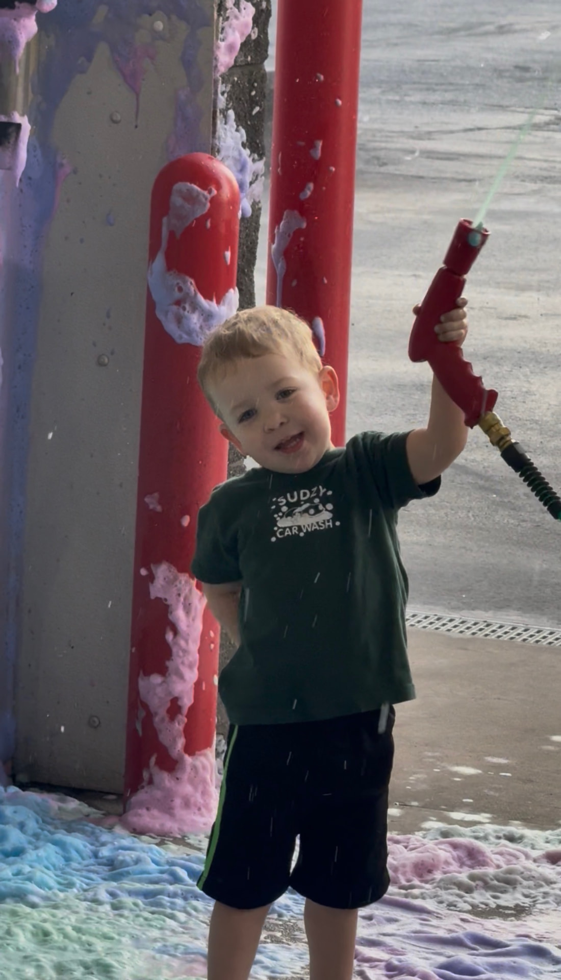 A young customer having fun with the Sudzy foam wand
